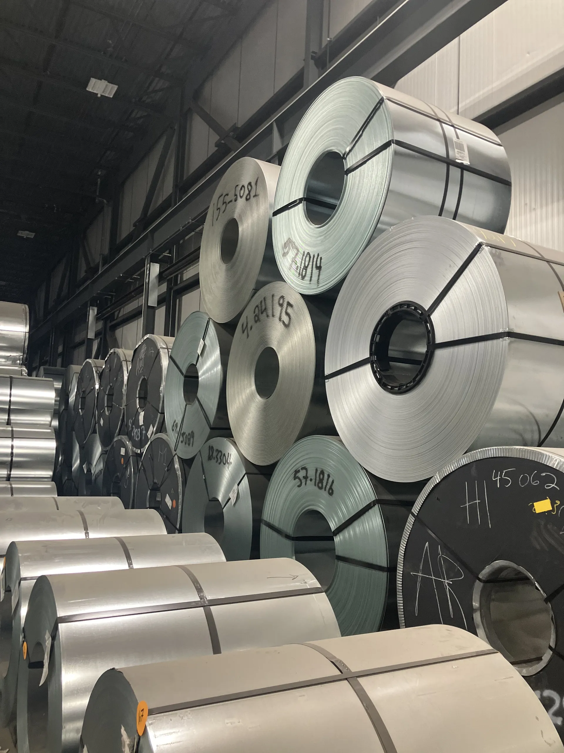 Steel coils stacked three high in a storage bay